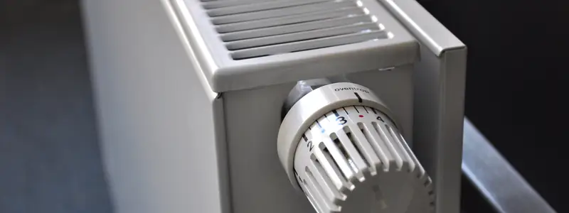 Close-up of a home radiator with its temperature valve